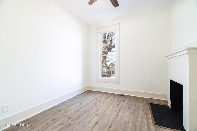 unfurnished living room with ceiling fan and light hardwood / wood-style flooring