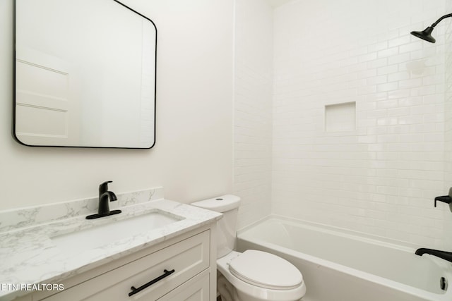 full bathroom with vanity, toilet, and tiled shower / bath combo