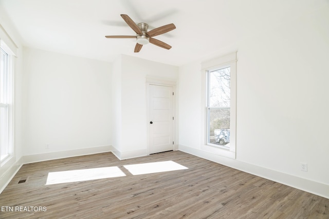 spare room featuring ceiling fan and light wood-type flooring