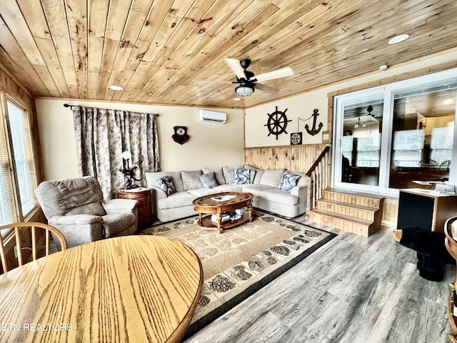 living room featuring wood ceiling, wooden walls, a wall unit AC, hardwood / wood-style flooring, and ceiling fan