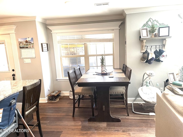 dining room featuring ornamental molding, dark hardwood / wood-style floors, and plenty of natural light