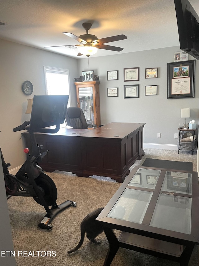 carpeted home office with ceiling fan