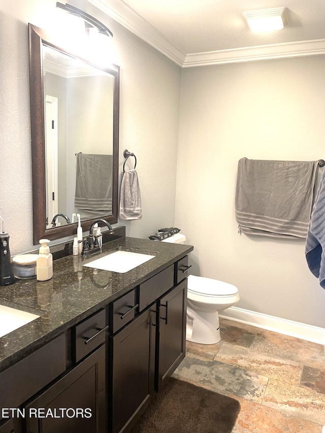 bathroom featuring crown molding, vanity, and toilet