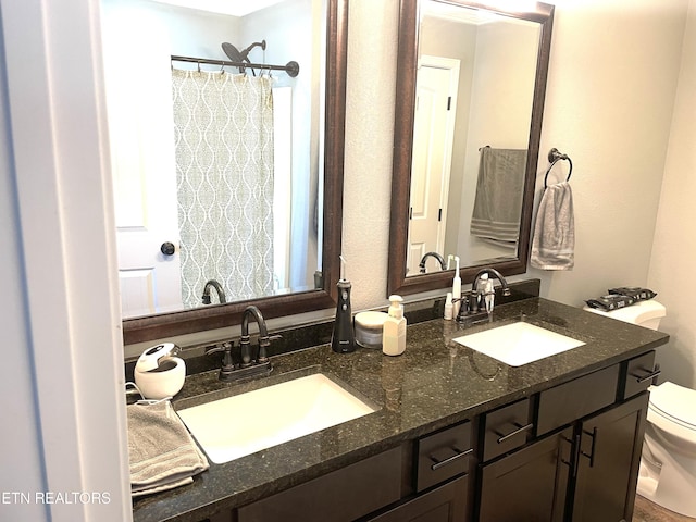 bathroom featuring vanity and toilet