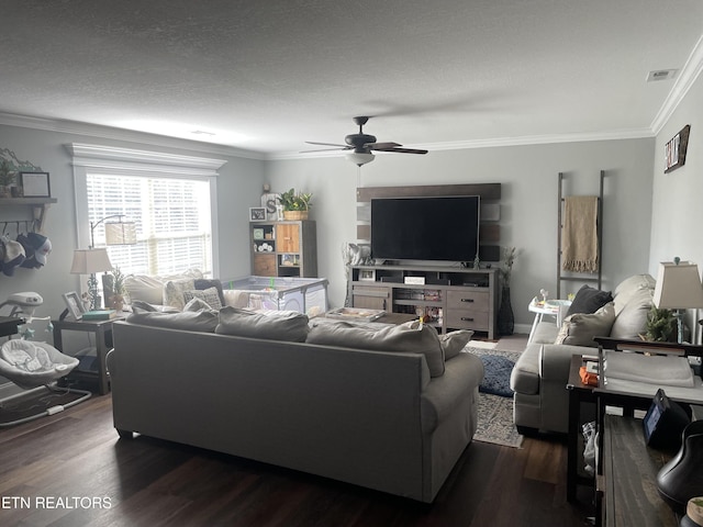 living room featuring crown molding, dark wood-type flooring, a textured ceiling, and ceiling fan