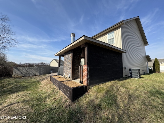 view of property exterior featuring a yard and central air condition unit