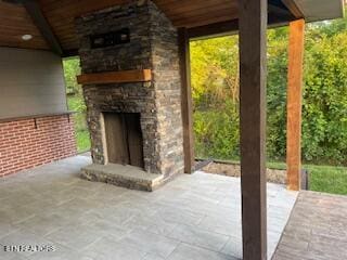 view of patio with an outdoor stone fireplace