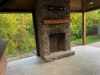 view of patio with an outdoor stone fireplace