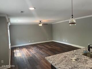 interior space with a ceiling fan, ornamental molding, dark wood-style floors, and baseboards