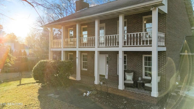 rear view of property with a balcony