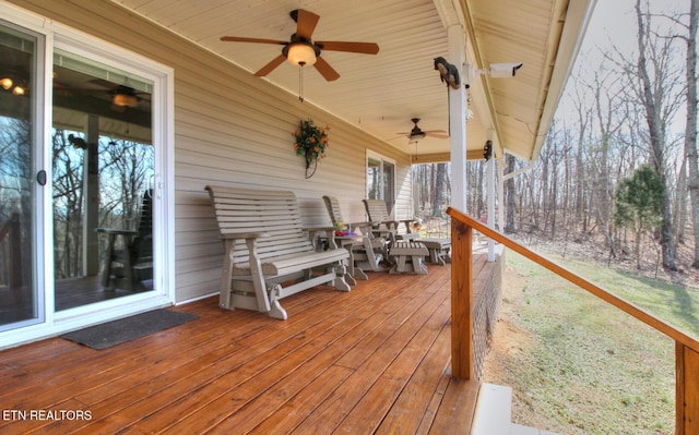 wooden terrace featuring ceiling fan