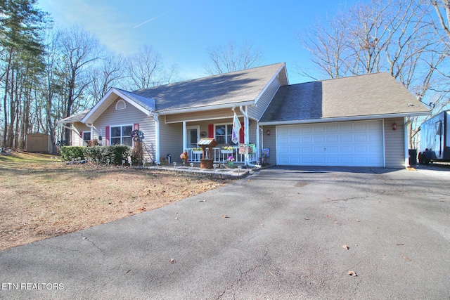 ranch-style house featuring a garage and covered porch