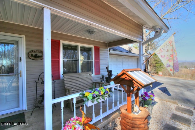 exterior space with a porch and a garage