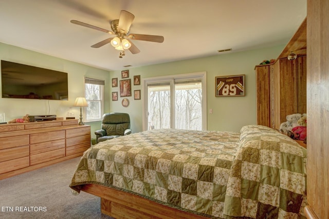 bedroom with ceiling fan, light colored carpet, and access to exterior