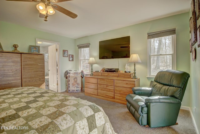 bedroom with connected bathroom, ceiling fan, and carpet flooring