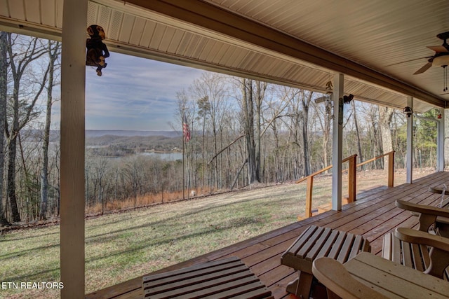 wooden deck with ceiling fan and a yard