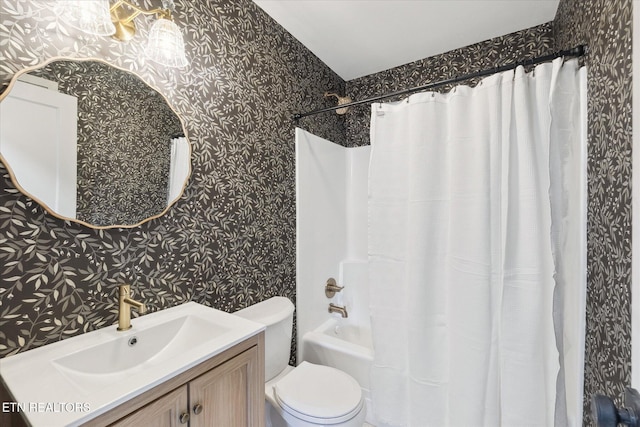 full bathroom featuring vanity, shower / bath combination with curtain, and toilet