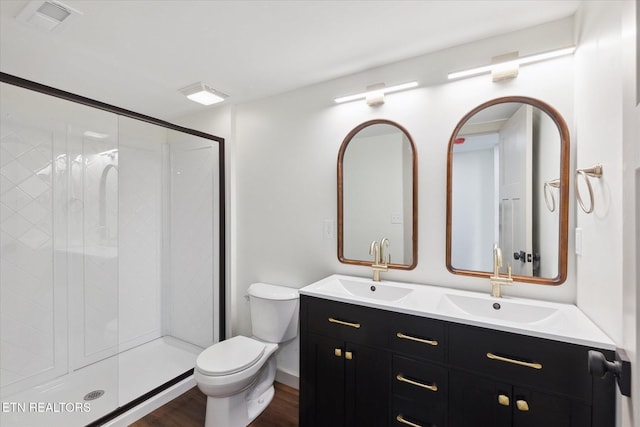 bathroom featuring an enclosed shower, vanity, hardwood / wood-style floors, and toilet