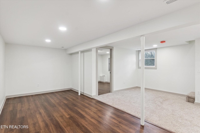 basement featuring dark hardwood / wood-style flooring