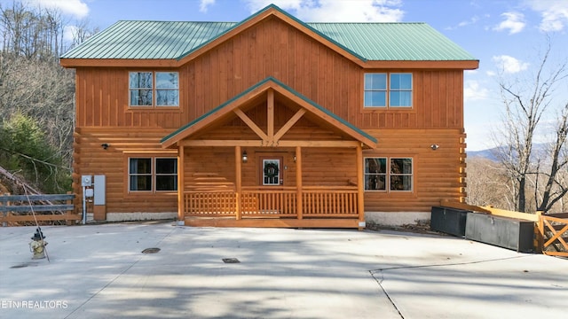 log-style house featuring a mountain view and covered porch