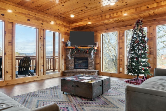 living room featuring a fireplace, wooden ceiling, and wood-type flooring