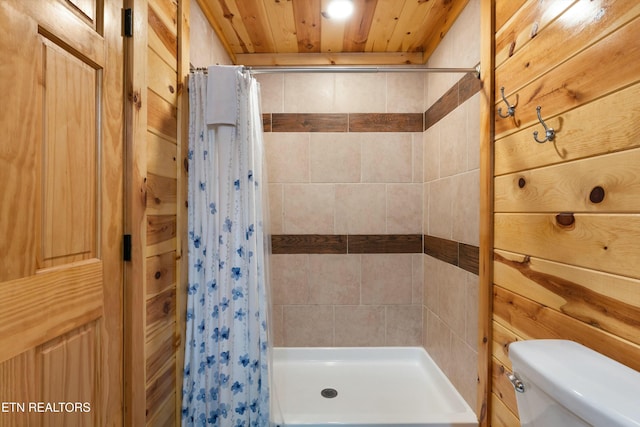 bathroom featuring a shower with curtain, wood ceiling, wooden walls, and toilet