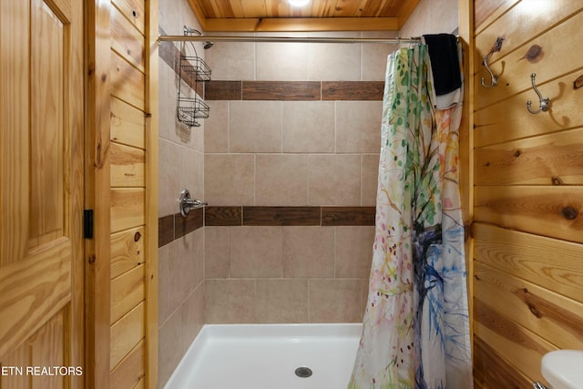 bathroom with wood ceiling and a shower with curtain