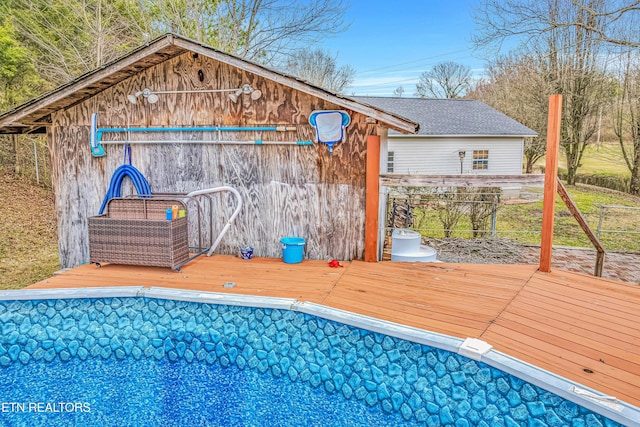 view of pool with a wooden deck