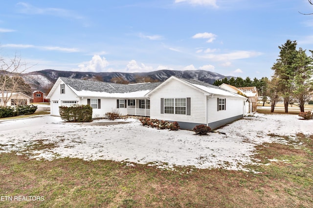 exterior space with a garage and a mountain view