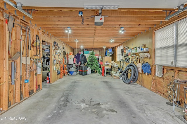 garage featuring a garage door opener and a workshop area