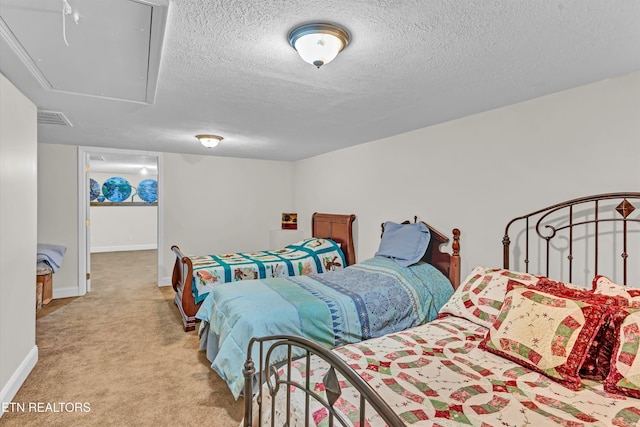 bedroom featuring light carpet and a textured ceiling