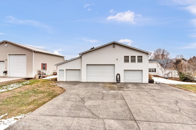 view of side of property with a yard and a garage