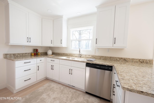 kitchen with dishwasher, sink, white cabinets, and light wood-type flooring