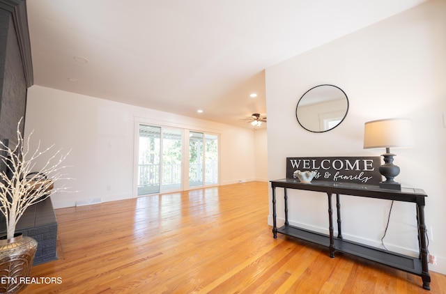 living room featuring light hardwood / wood-style floors and ceiling fan