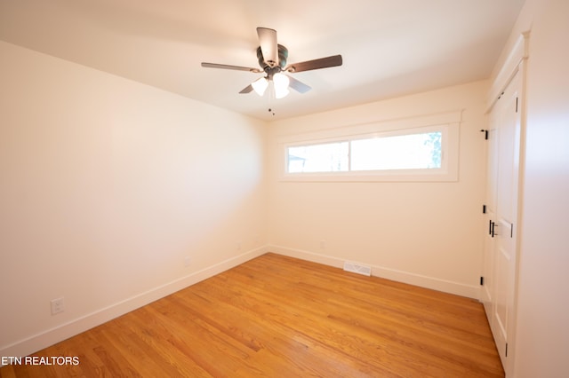 spare room featuring ceiling fan and light wood-type flooring