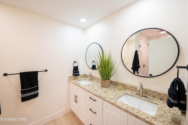 bathroom with vanity and wood-type flooring