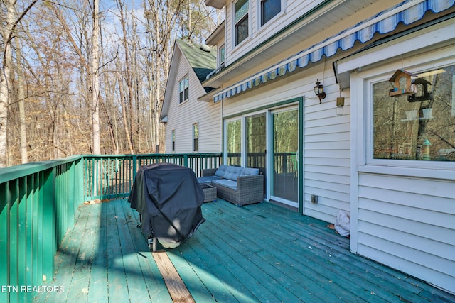 deck featuring outdoor lounge area and a grill