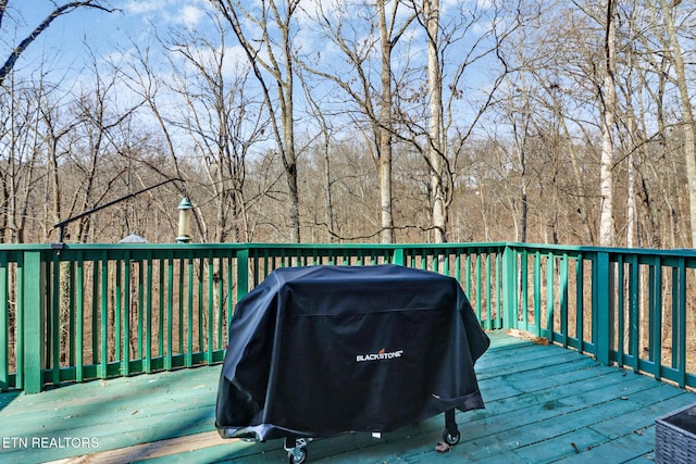 wooden terrace featuring a grill