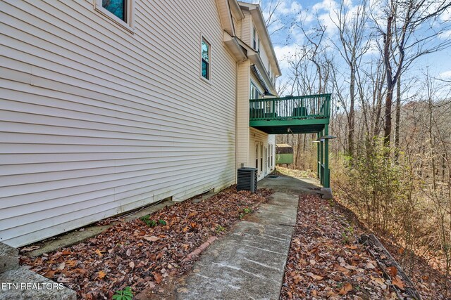 view of side of home featuring a wooden deck and cooling unit