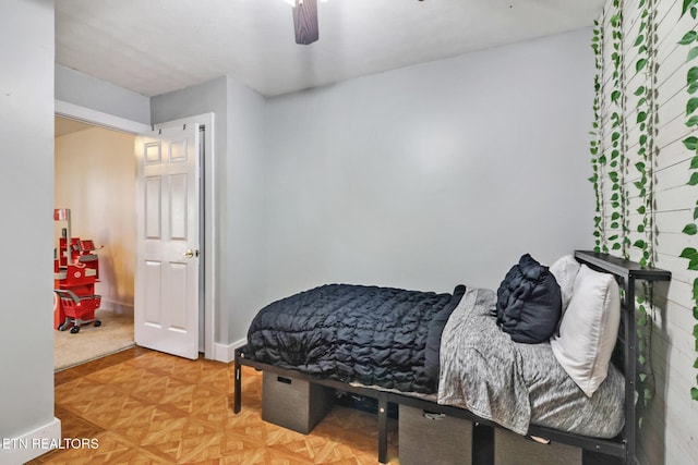 bedroom featuring ceiling fan and parquet flooring