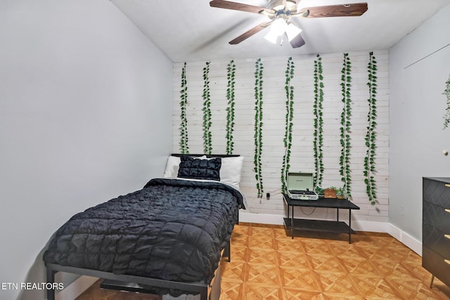 bedroom featuring ceiling fan and parquet flooring