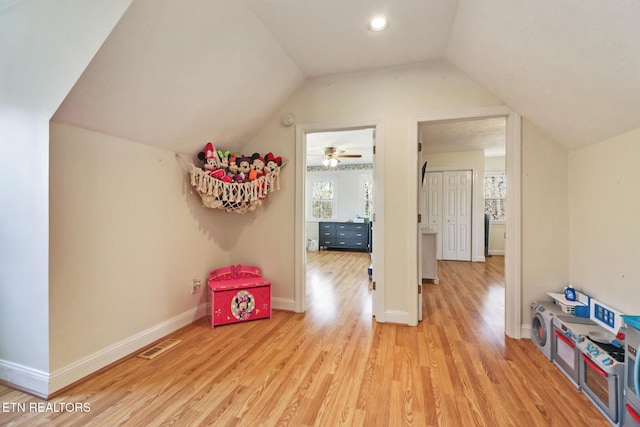 interior space featuring vaulted ceiling and light wood-type flooring