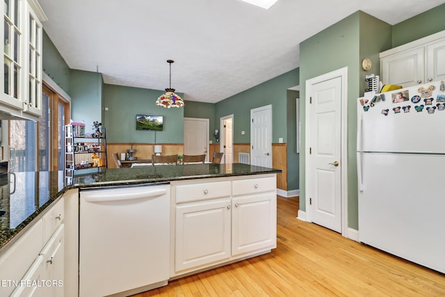 kitchen featuring pendant lighting, white appliances, light hardwood / wood-style floors, and white cabinets