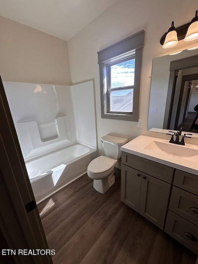 bathroom with vanity, hardwood / wood-style floors, and toilet