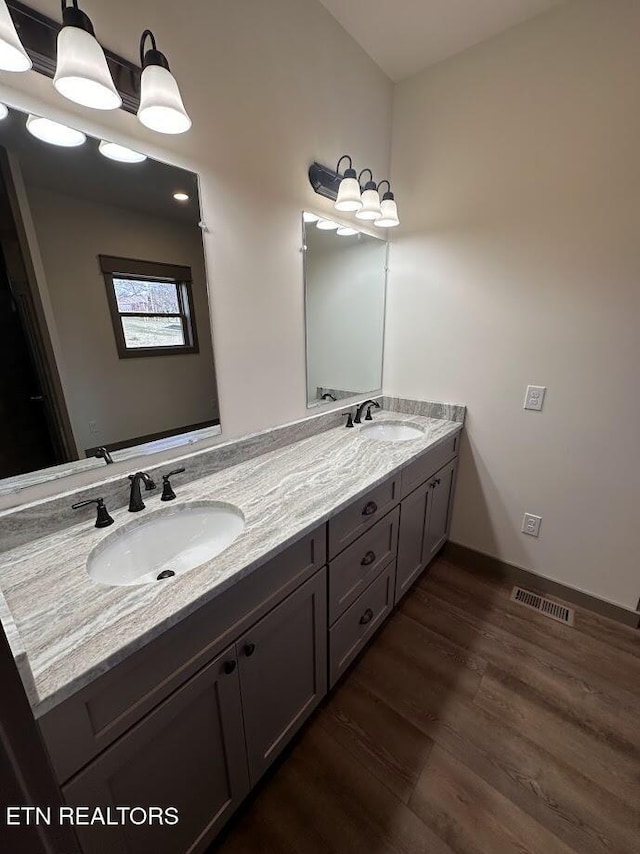 bathroom with vanity and hardwood / wood-style floors