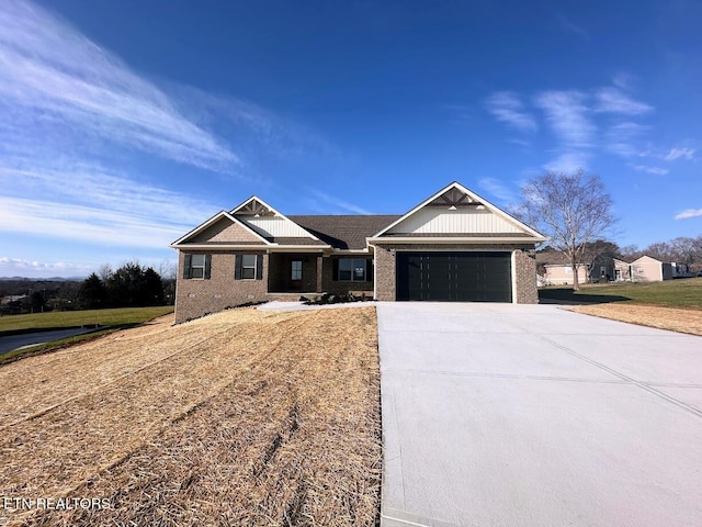 view of front facade with a garage, brick siding, driveway, and a front lawn