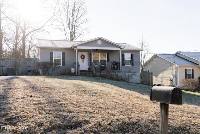 single story home featuring a porch and a front lawn