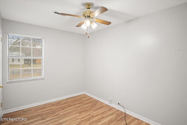 spare room with light hardwood / wood-style flooring and ceiling fan