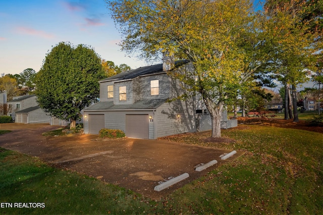 view of front of home featuring a yard and a garage