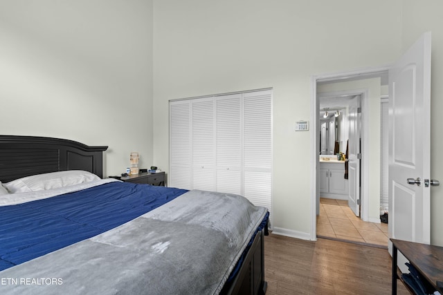 bedroom with hardwood / wood-style floors and a closet